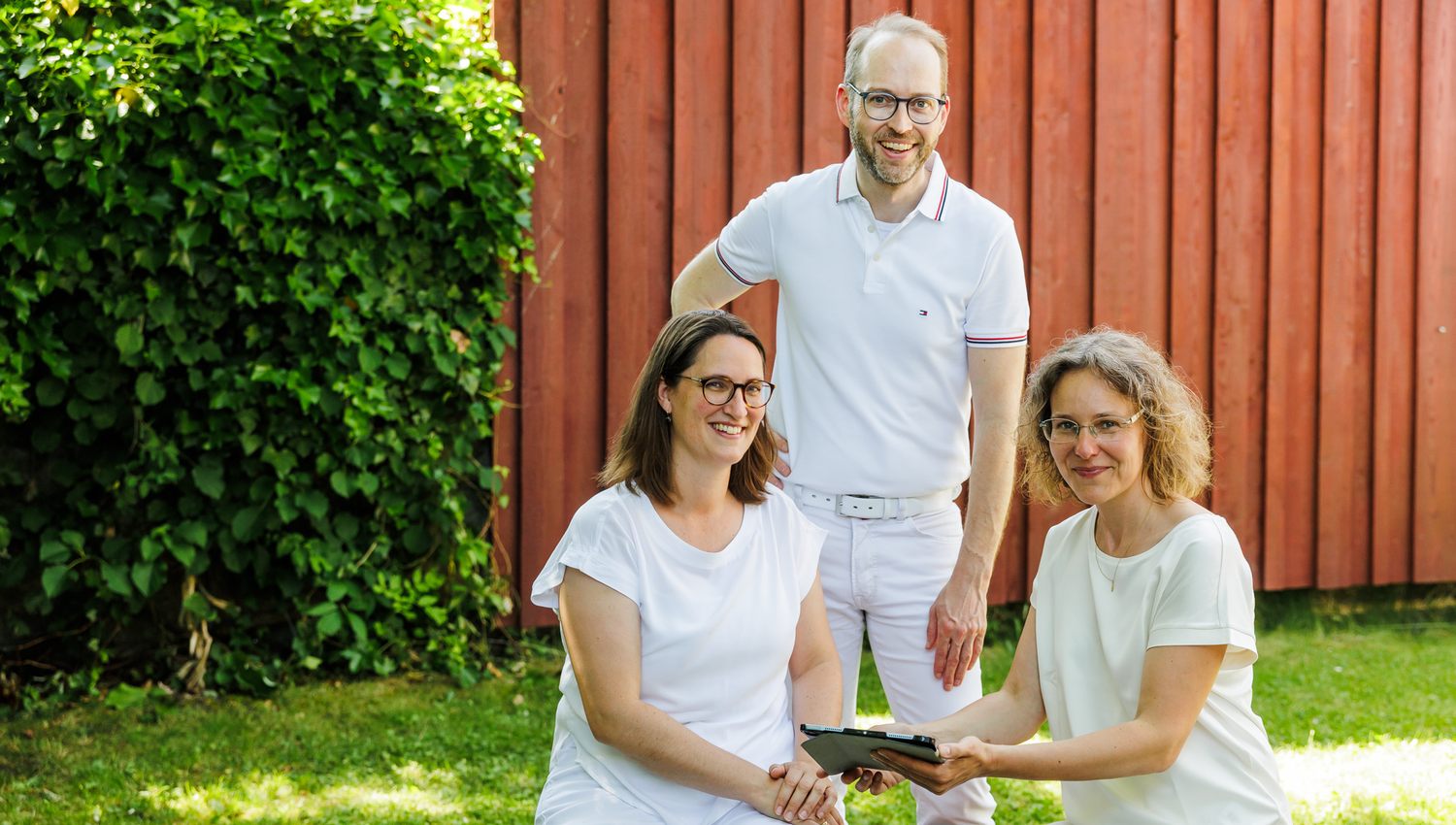 Das Ärzteteam bestehend aus Dr. Friederike Preul, Dr. Florian Kircher und Frau Miller stehen vor der Praxis und besprechen sich